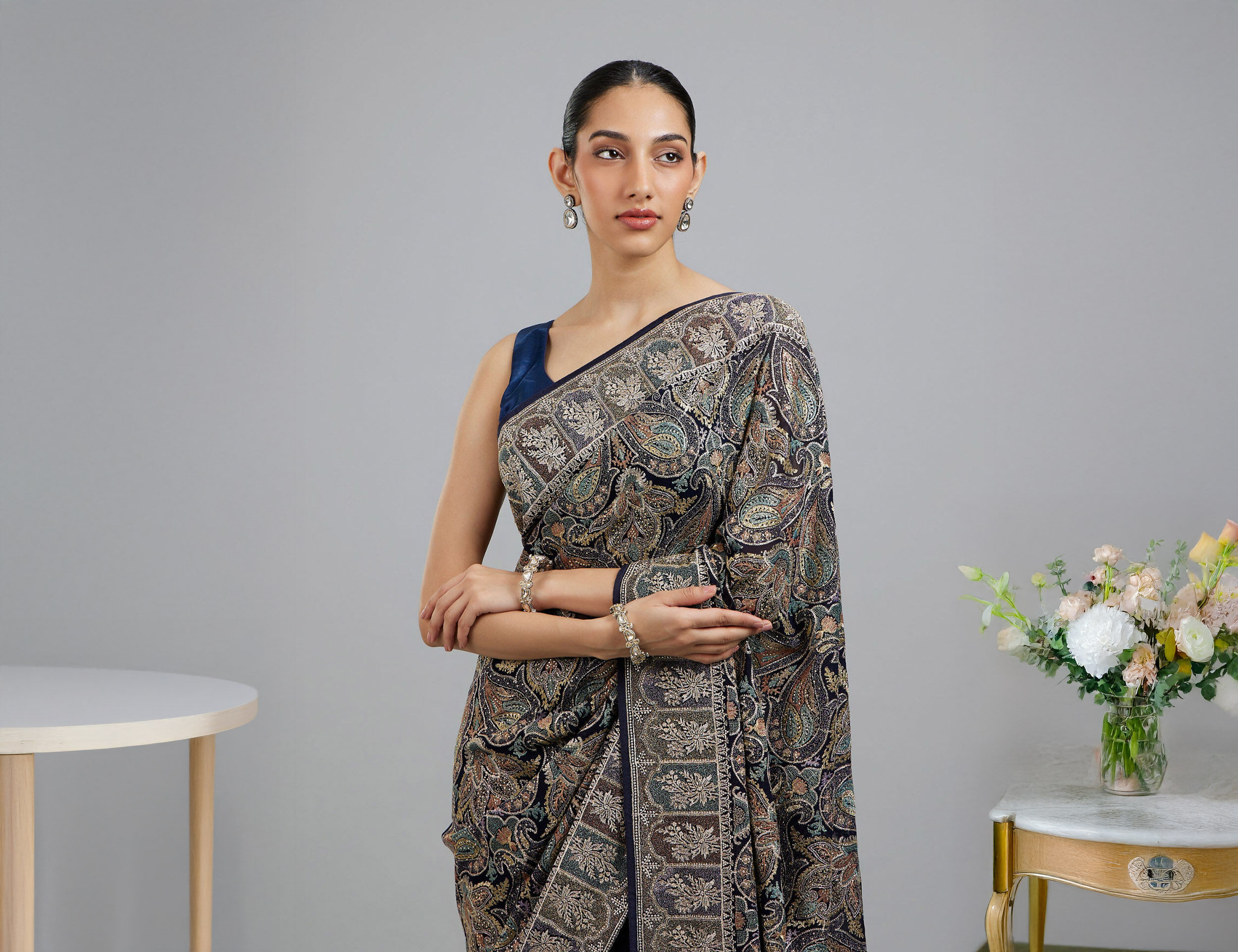 Women wearing stylish black zaree work saree for wedding ceremony